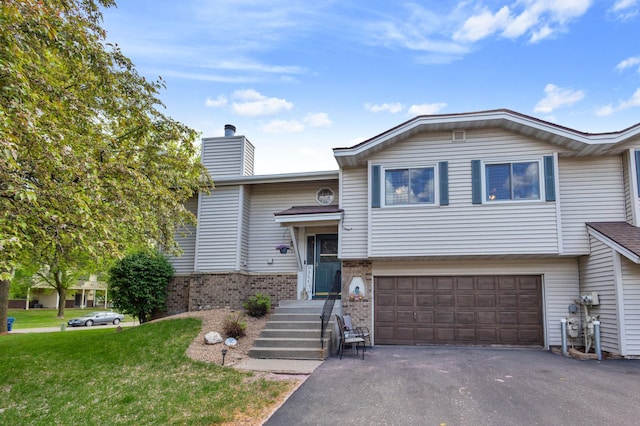 1060 Aston Cir, Burnsville, MN 55337 - view of front of property featuring an attached garage, asphalt driveway, a front yard, a chimney, and brick siding