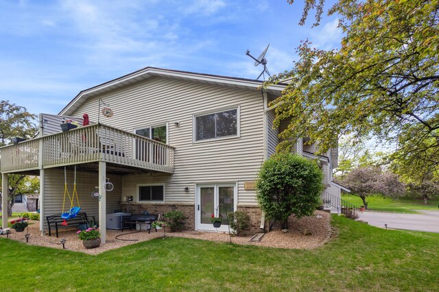 1060 Aston Cir, Burnsville, MN 55337 - rear view of house featuring a lawn, brick siding, a wooden deck, and central air condition unit