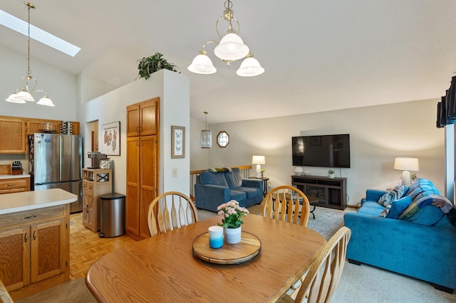 1060 Aston Cir, Burnsville, MN 55337 - dining room with a chandelier, a skylight, and vaulted ceiling