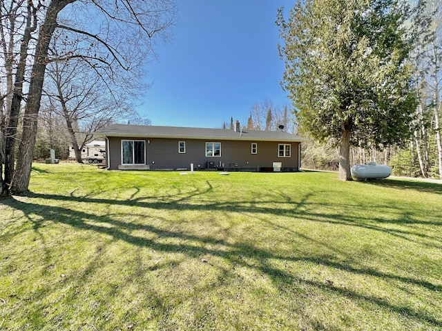 rear view of property with a yard