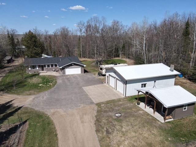 view from above of property featuring a heavily wooded area
