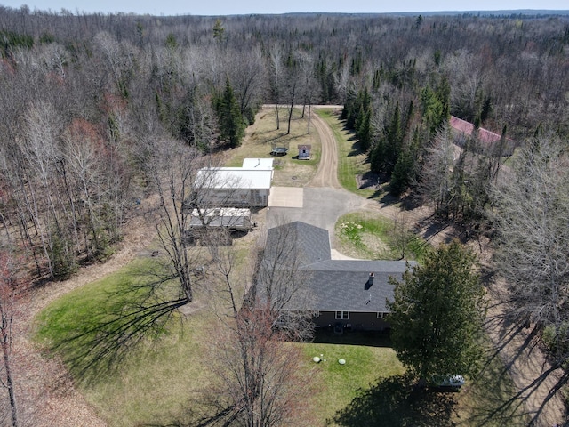 view of property location with a heavily wooded area