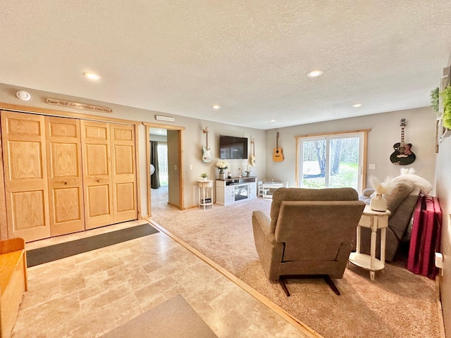 living room featuring a textured ceiling and recessed lighting