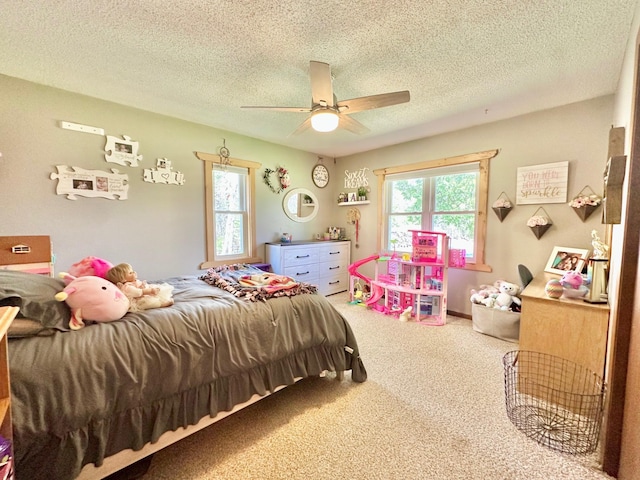 carpeted bedroom with a textured ceiling and ceiling fan