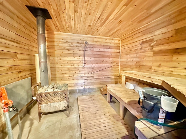 sauna featuring wooden ceiling and wood walls