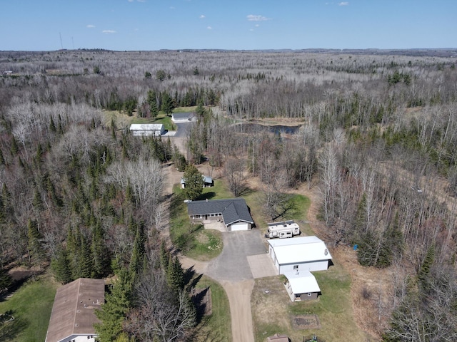 view of property location with a forest