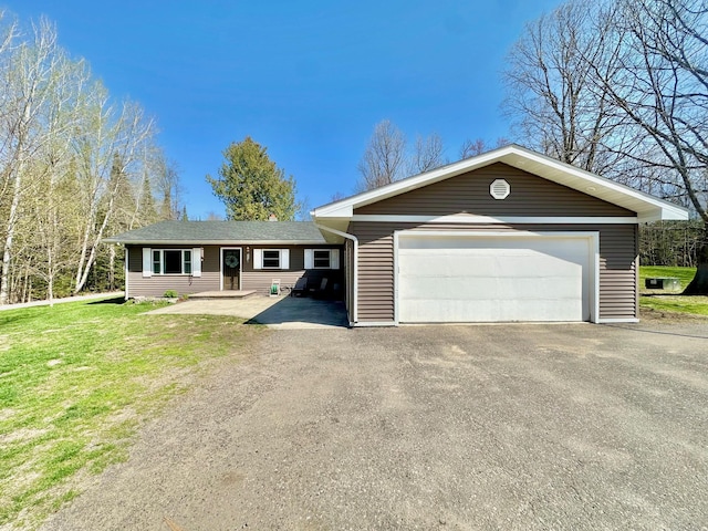 single story home featuring a detached garage