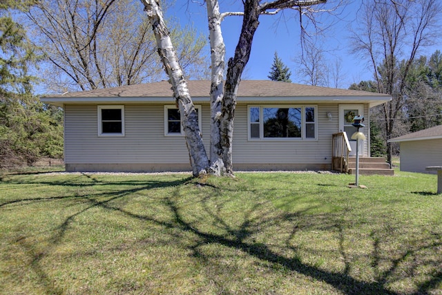 single story home featuring roof with shingles and a front yard