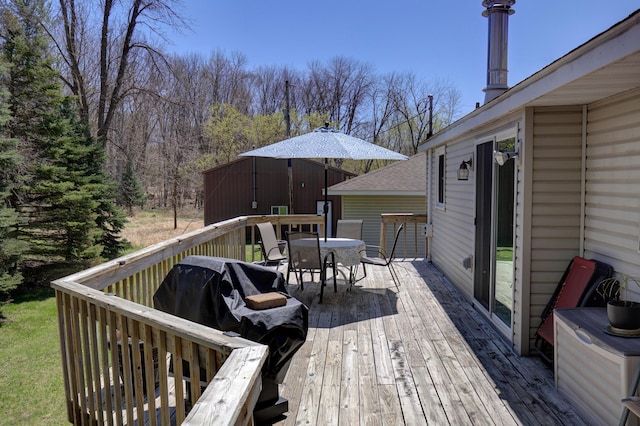 wooden terrace featuring outdoor dining area