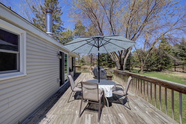 deck with area for grilling and outdoor dining space