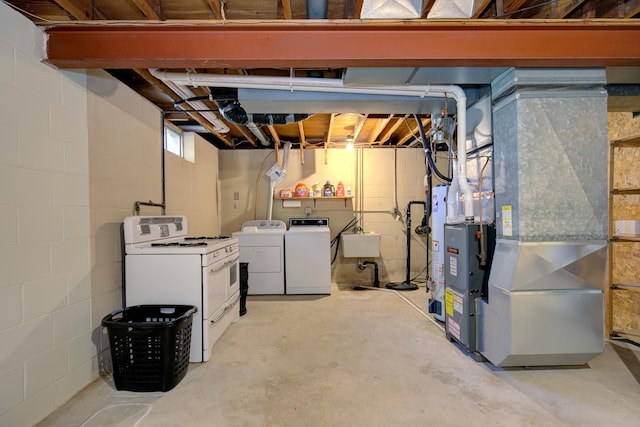 below grade area featuring independent washer and dryer, heating unit, and a sink