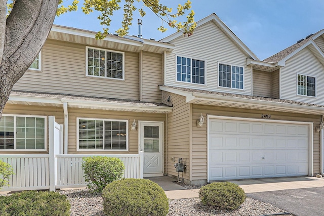 2492 Yellowstone Dr Unit 82, Hastings, MN 55033 - view of property with a garage, a shingled roof, and asphalt driveway