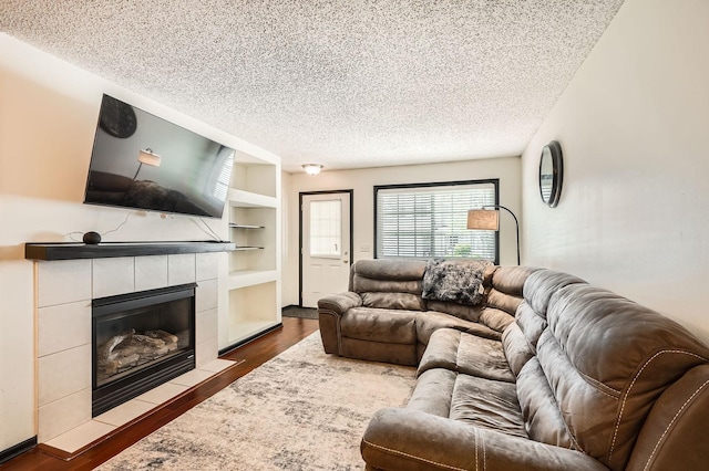 2492 Yellowstone Dr Unit 82, Hastings, MN 55033 - living area featuring a textured ceiling, a tile fireplace, dark wood-style floors, and built in features