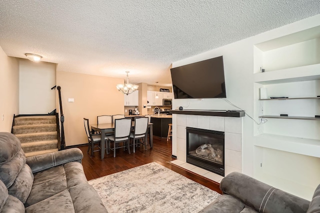 2492 Yellowstone Dr Unit 82, Hastings, MN 55033 - living area with a textured ceiling, a chandelier, dark wood-type flooring, stairs, and a fireplace