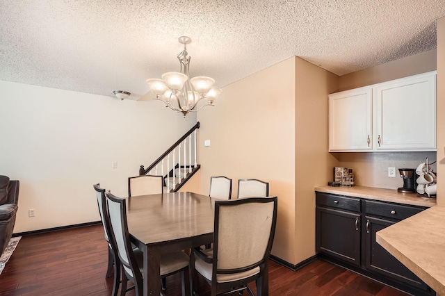 2492 Yellowstone Dr Unit 82, Hastings, MN 55033 - dining area with dark wood-type flooring, a chandelier, a textured ceiling, baseboards, and stairway