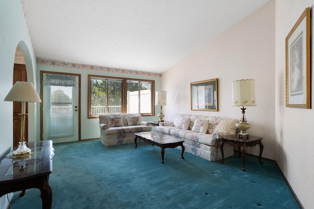 carpeted living area with lofted ceiling, a textured ceiling, and arched walkways