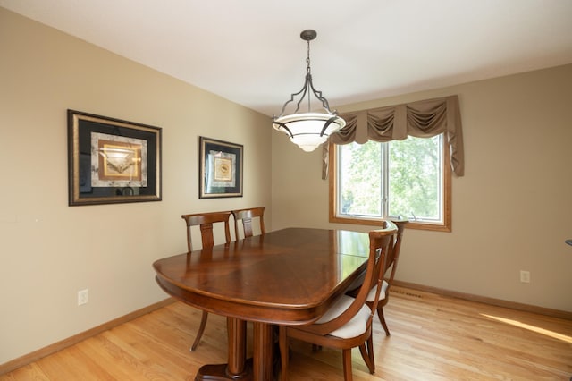 dining room featuring light wood-style floors and baseboards