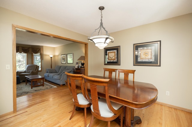 dining room featuring light wood-style floors and baseboards