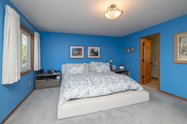 carpeted bedroom with baseboards