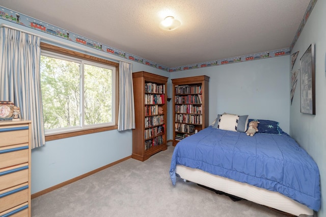 bedroom featuring a textured ceiling, carpet flooring, and baseboards