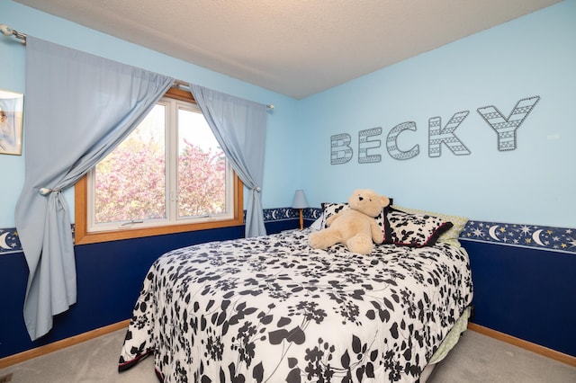 carpeted bedroom featuring baseboards