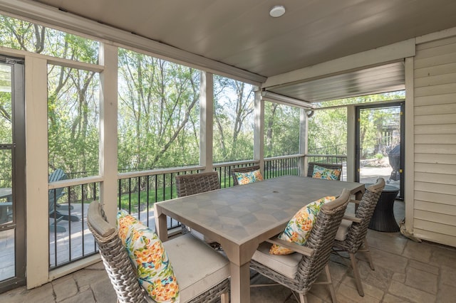 sunroom / solarium featuring outdoor dining space