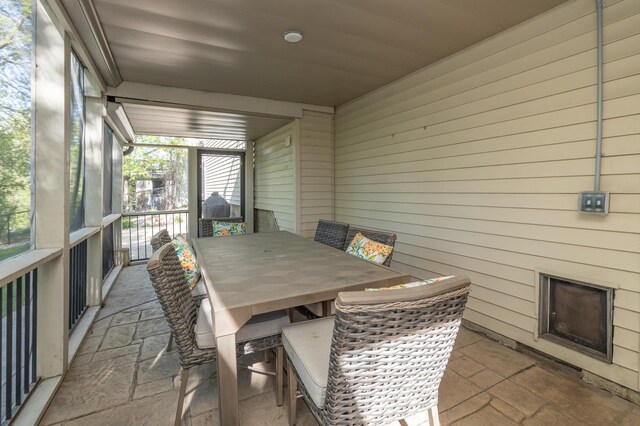 sunroom with outdoor dining area