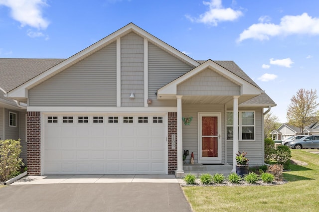 11062 16th St NE, Saint Michael, MN 55376 - view of front of home with a garage, brick siding, driveway, a front yard, and covered porch