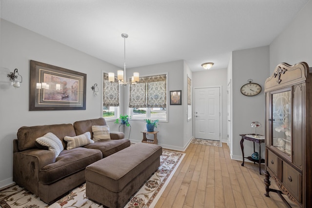 11062 16th St NE, Saint Michael, MN 55376 - living area featuring light wood-style floors, a chandelier, and baseboards