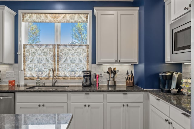 11062 16th St NE, Saint Michael, MN 55376 - kitchen featuring a sink, decorative backsplash, and white cabinetry