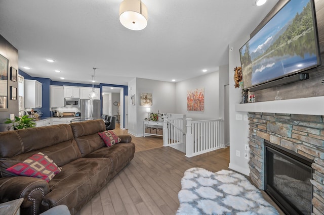 11062 16th St NE, Saint Michael, MN 55376 - living room featuring wood finished floors, baseboards, recessed lighting, and a fireplace