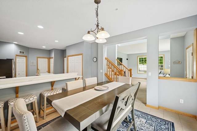 12245 Urbank St NE Unit E, Blaine, MN 55449 - dining room featuring stairway, recessed lighting, baseboards, light tile patterned flooring, and a chandelier
