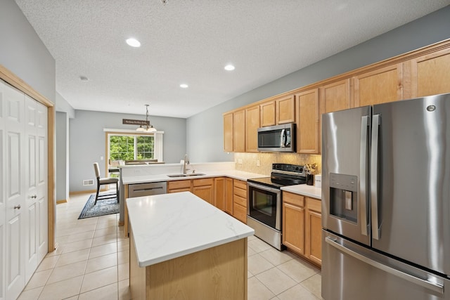 12245 Urbank St NE Unit E, Blaine, MN 55449 - kitchen with appliances with stainless steel finishes, a sink, a peninsula, light tile patterned floors, and recessed lighting