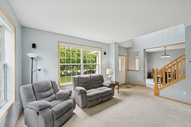 12245 Urbank St NE Unit E, Blaine, MN 55449 - carpeted living area featuring baseboards, stairs, and a textured ceiling