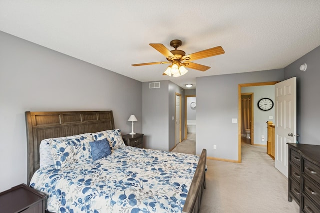 12245 Urbank St NE Unit E, Blaine, MN 55449 - bedroom with light colored carpet, ceiling fan, baseboards, and ensuite bathroom