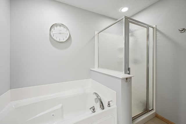 12245 Urbank St NE Unit E, Blaine, MN 55449 - bathroom with a stall shower, a bath, and tile patterned flooring