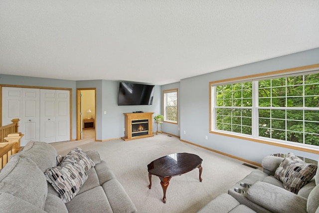 12245 Urbank St NE Unit E, Blaine, MN 55449 - living room with baseboards, a glass covered fireplace, and light colored carpet