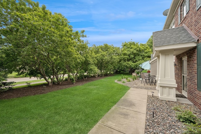 12245 Urbank St NE Unit E, Blaine, MN 55449 - view of green lawn with a patio area