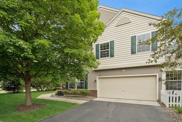 12245 Urbank St NE Unit E, Blaine, MN 55449 - view of front of house with driveway, a garage, central AC, and a front lawn