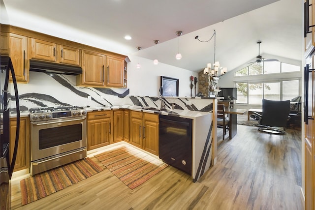 kitchen featuring stainless steel range with gas cooktop, under cabinet range hood, light wood-style floors, a peninsula, and a ceiling fan