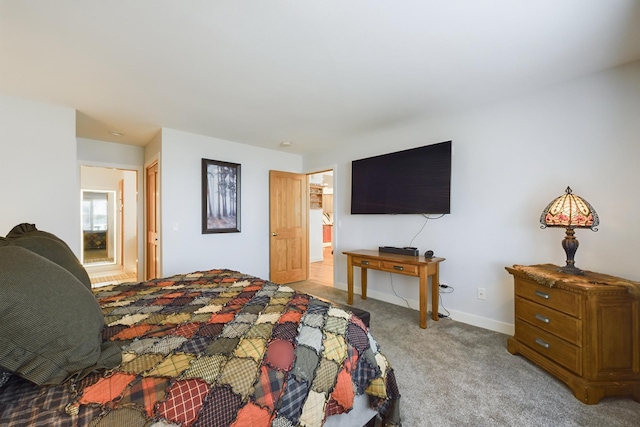 bedroom featuring light carpet and baseboards