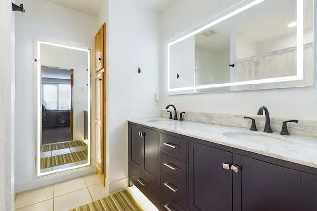 bathroom featuring tile patterned flooring and double vanity