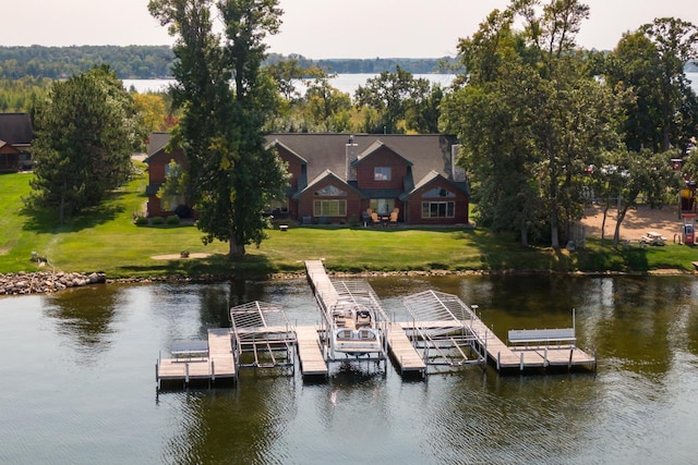 dock area with a water view and a lawn