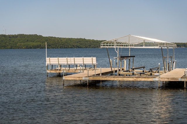 dock area with a water view and boat lift