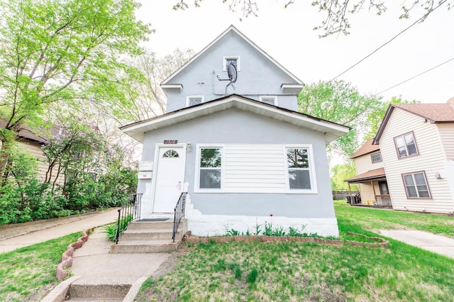 1510 Grand St NE, Minneapolis, MN 55413 - view of front of home with stucco siding and a front yard
