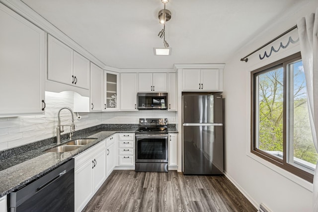 kitchen with a sink, tasteful backsplash, plenty of natural light, and appliances with stainless steel finishes