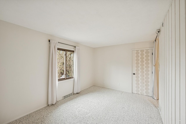 spare room featuring baseboards and visible vents