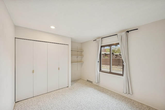 unfurnished bedroom with a closet, visible vents, and recessed lighting