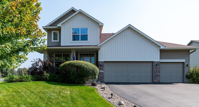 view of front facade with board and batten siding, driveway, an attached garage, a front lawn, and stone siding