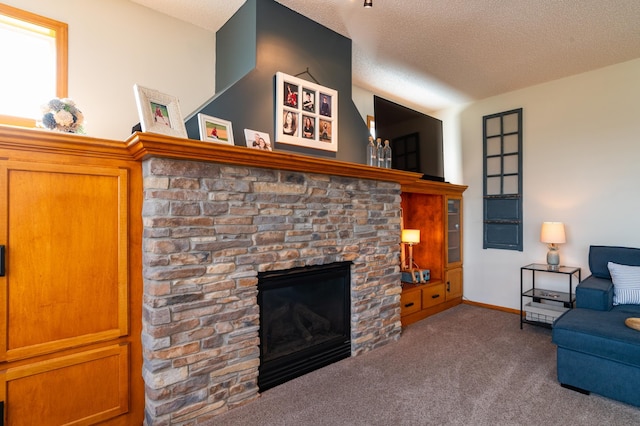 living room with a fireplace, carpet, a textured ceiling, and baseboards